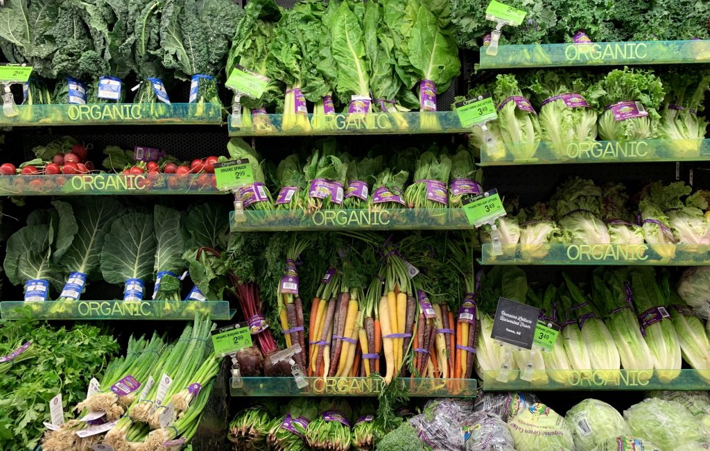 fresh organic vegetables in the produce section of the grocery store e1616580717342